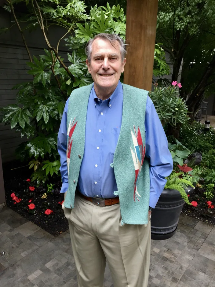 Garrison Wilkes smiling, standing in a garden.